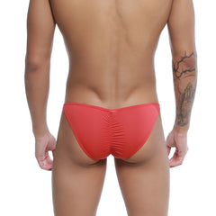 Red u-station me bikini swim trunks with ruched back design in form-fitting fabric for swimwear use shown from back side