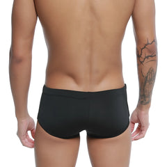 Black men’s u-station Brazilian swim trunks in smooth, form-fitting black fabric perfect for swimming and beachwear