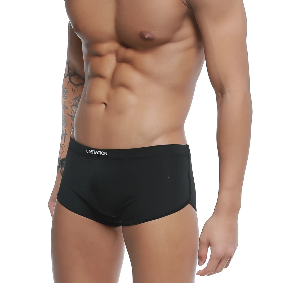 Black ua station briefs with sleek form fitting design and subtle white branding on waistband u station brazilian trunk