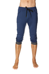 Navy blue ultra-flex tri-color cuffed yoga capri joggers with white side panels and black drawstring waistband