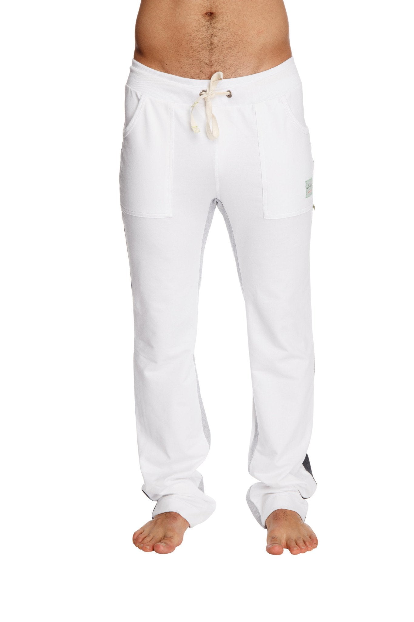 White ultra flex yoga sweatpants with drawstring, side pockets, and a small brand tag on the thigh for comfort and flexibility