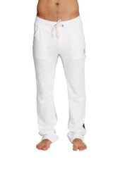 White ultra flex yoga sweatpants with drawstring, side pockets, and a small brand tag on the thigh for comfort and flexibility