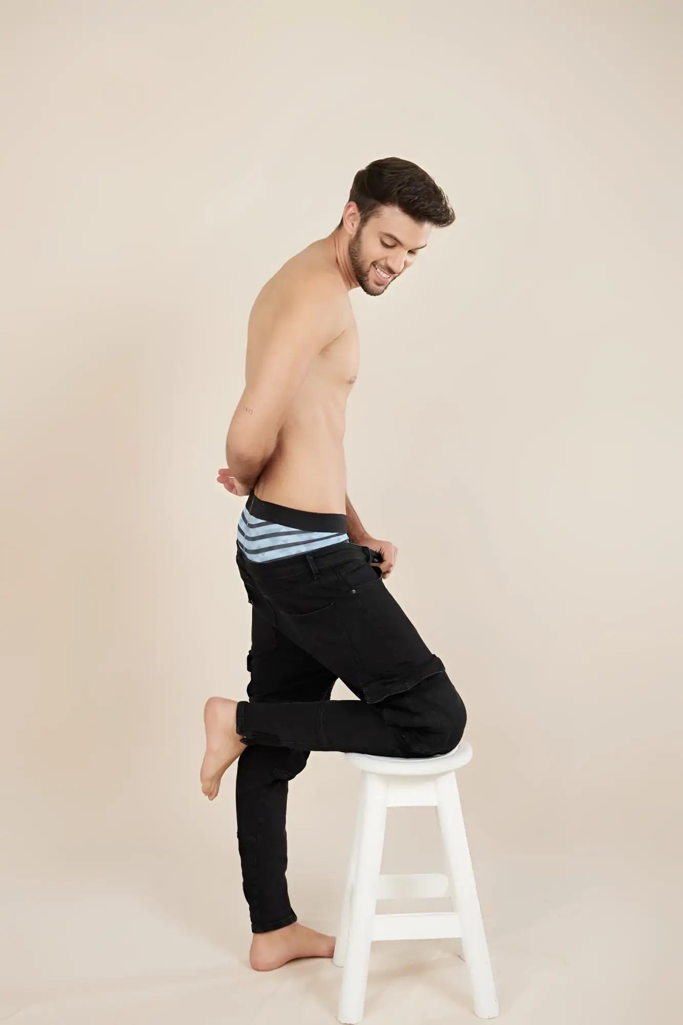 Black denim jeans unico 23050100116 espectaculo trunks with a turquoise striped waistband showing the front view
