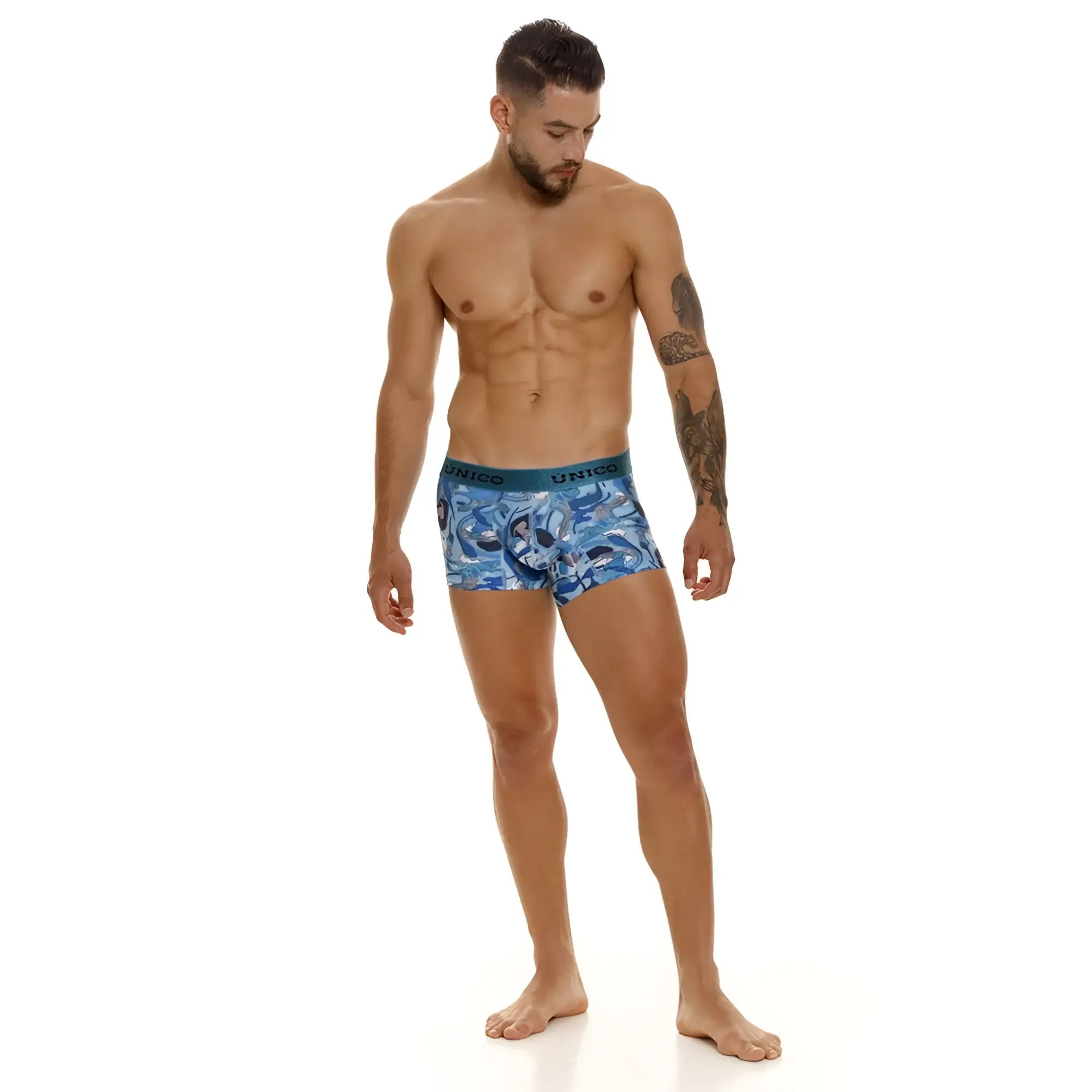 Blue patterned unico trunks with teal waistband featuring unico brand name in color 46-Blue design