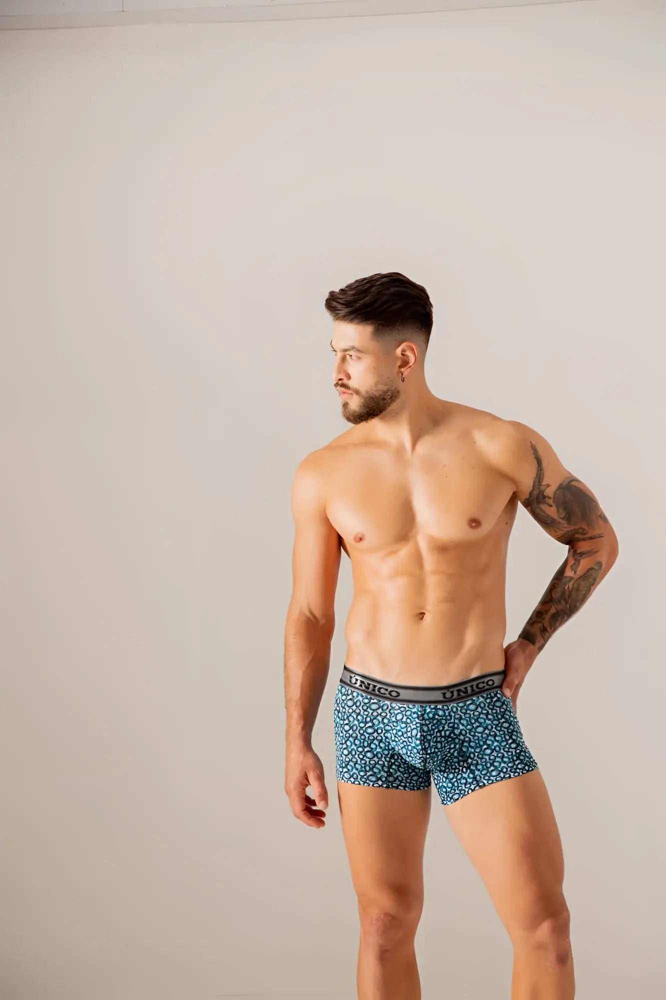Blue patterned unico 24020100110 redondel trunks with gray waistband featuring the unico brand name in blue color