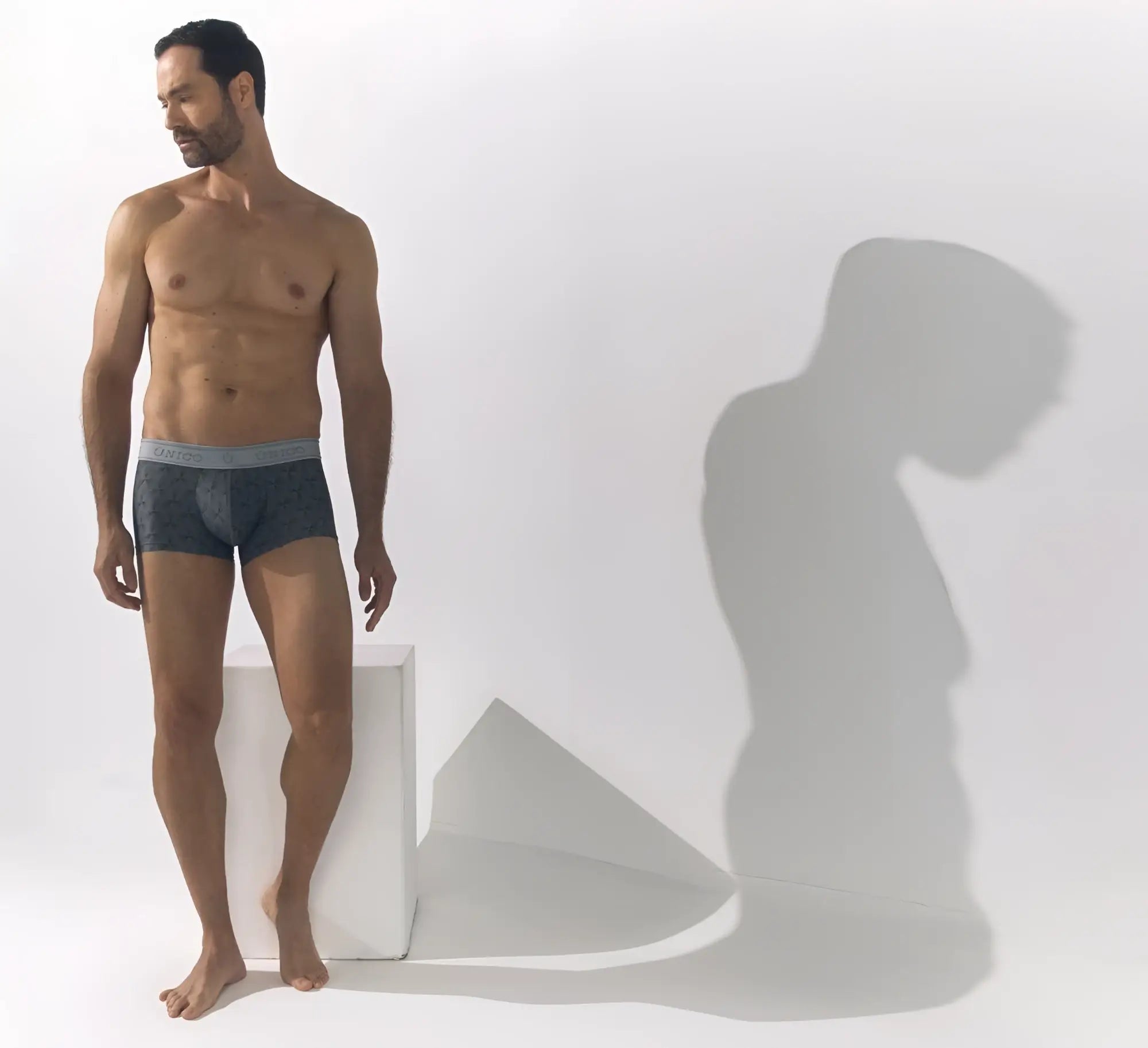 Dark gray calvin klein chisell trunks with light gray waistband featuring the calvin klein logo color 59 gray