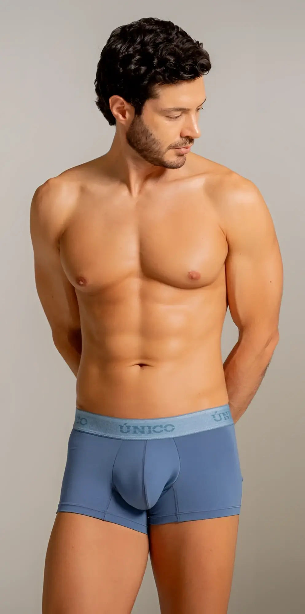 Blue unico men’s boxer briefs with light blue elastic waistband featuring unico logo in teal color for everyday use