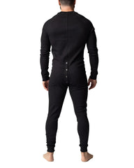 Back view of a black long-sleeved one-piece thermal union suit with a button-down back for warmth and comfort