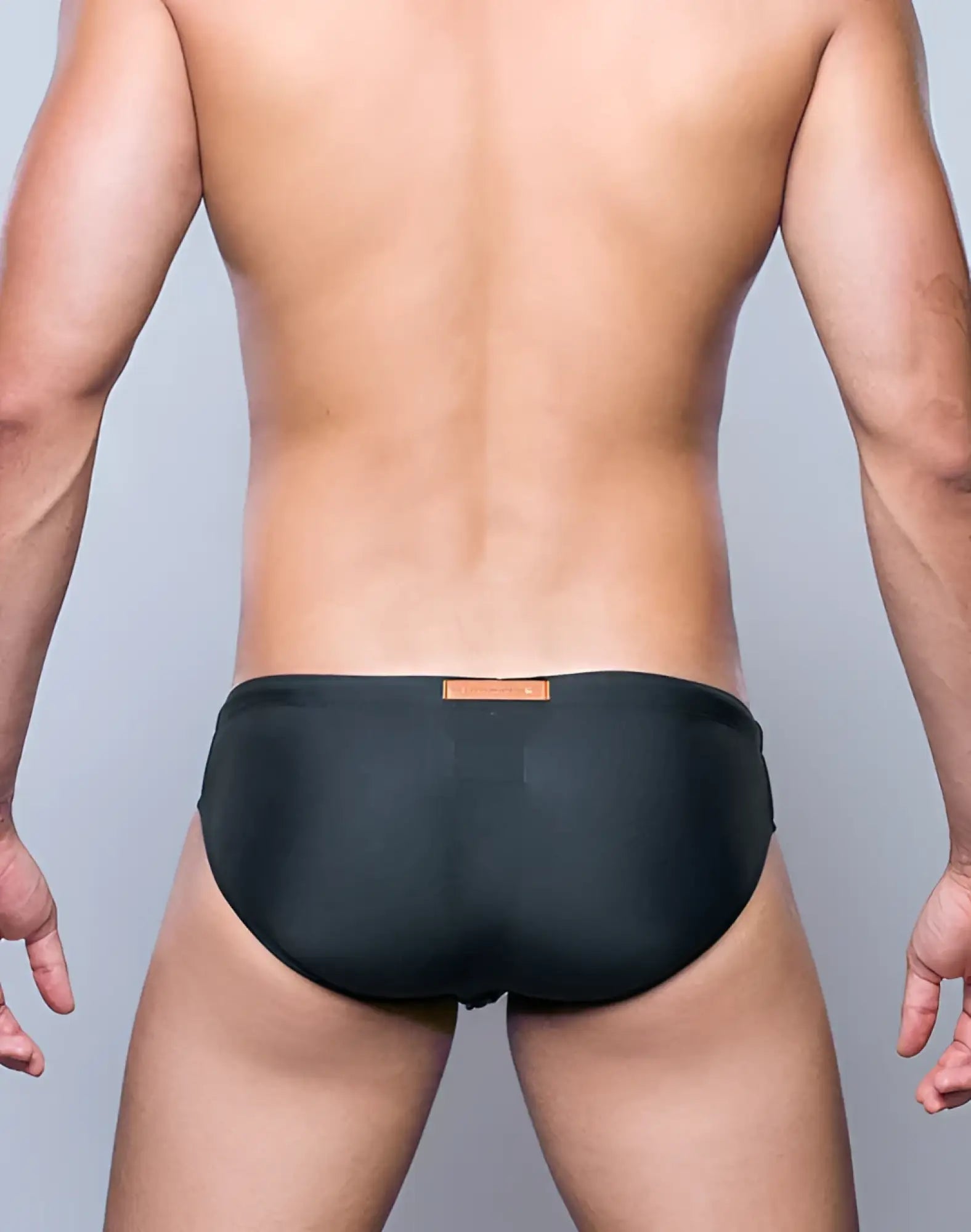 Black swim trunks v10 core bikini with small orange label at waistband designed for swimming and beach use