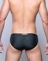 Black swim trunks v10 core bikini with small orange label at waistband designed for swimming and beach use