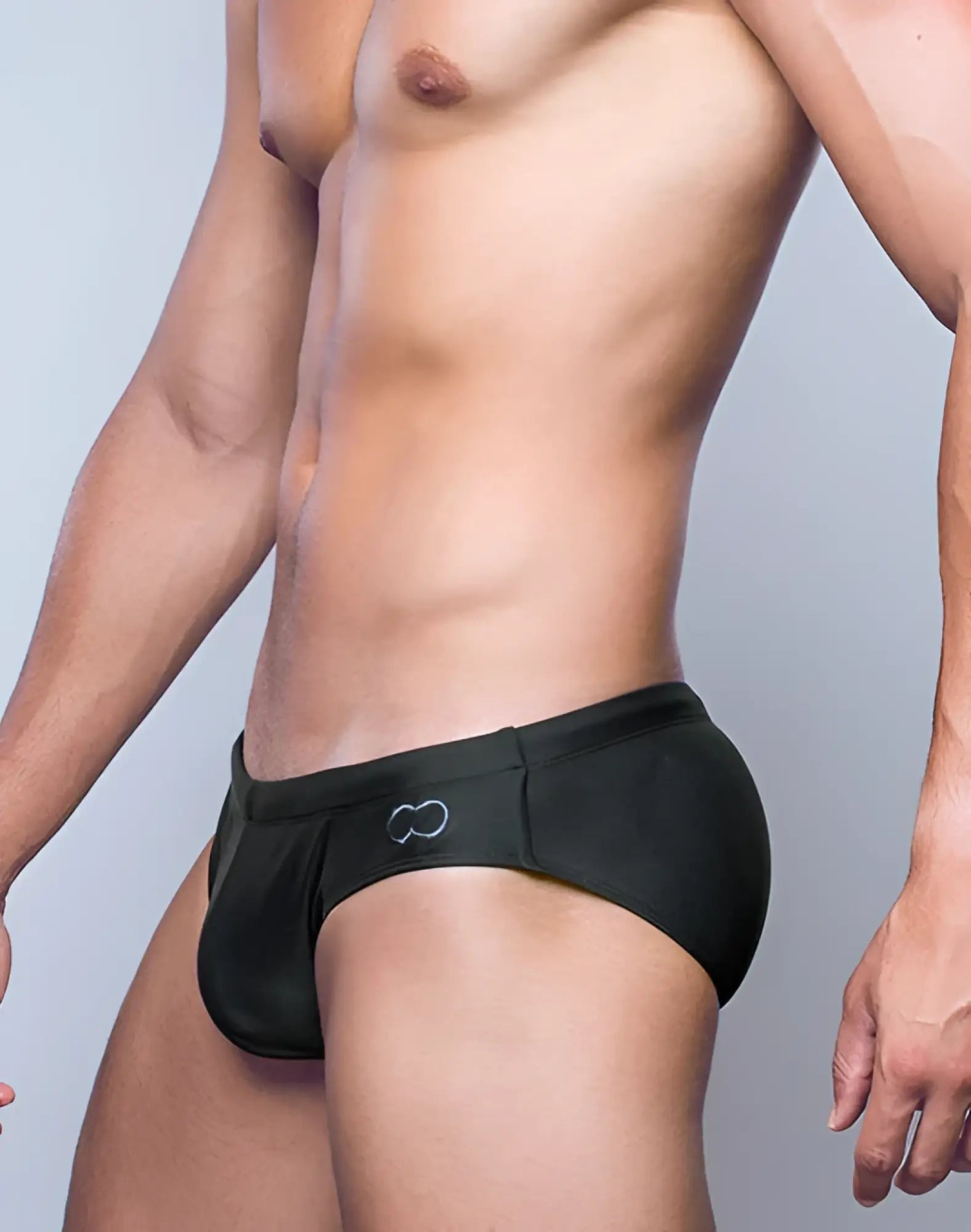 V10 core bikini black swim trunks with subtle white infinity symbol logo on the side for beach and pool use