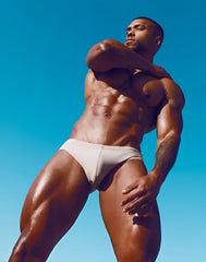 A man wearing white form-fitting briefs v10 core bikini highlighting comfortable stretch fabric and sleek design