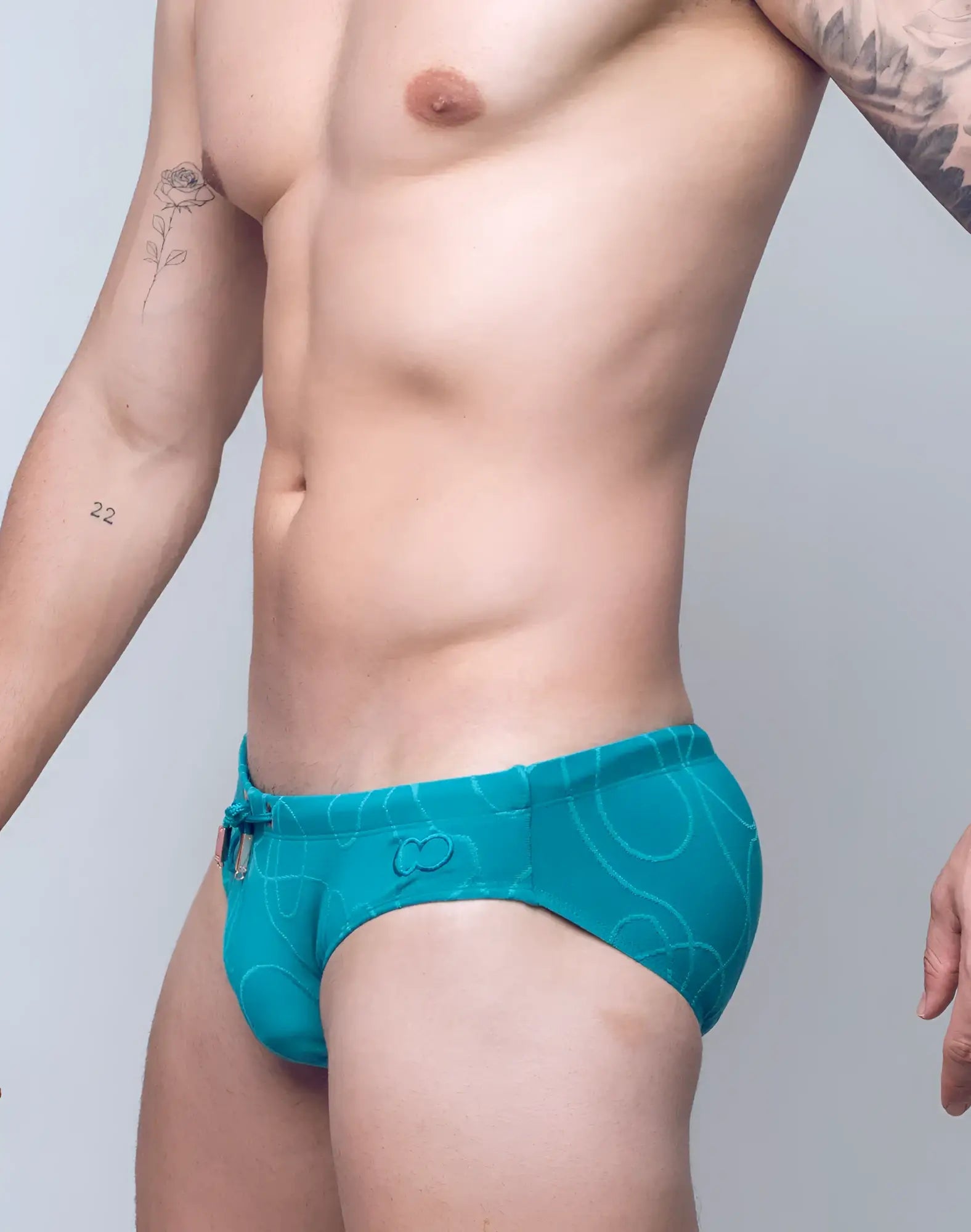 Turquoise v10 ripple textured swim brief with subtle abstract pattern and adjustable drawstring waistband
