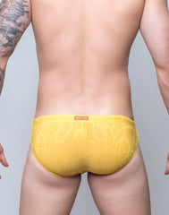 Yellow V10 ripple textured swim brief featuring subtle white abstract line pattern ideal for swimming and beachwear