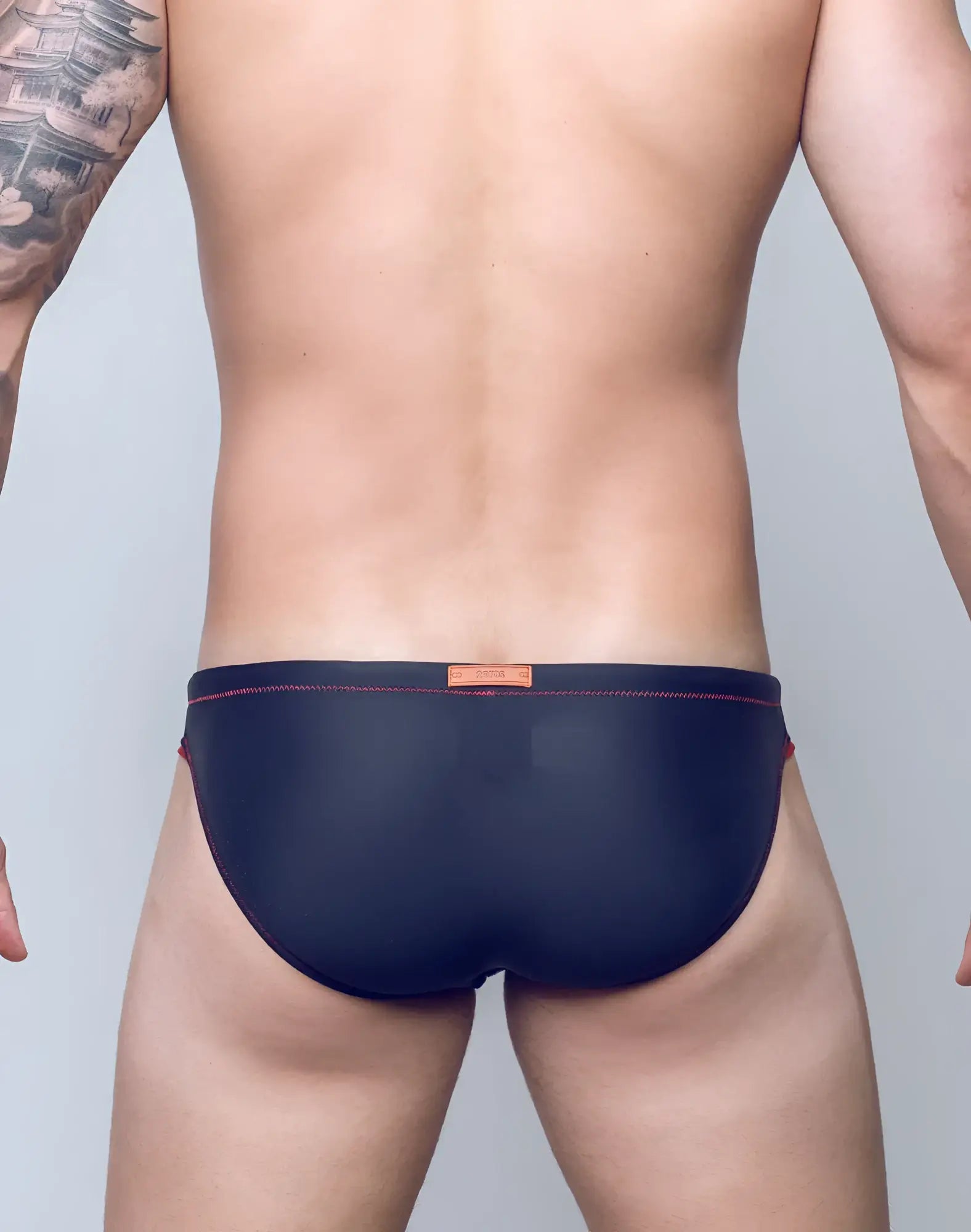 Navy blue v22 rapid swim brief with red stitching and orange brand tag designed for quick drying and comfort