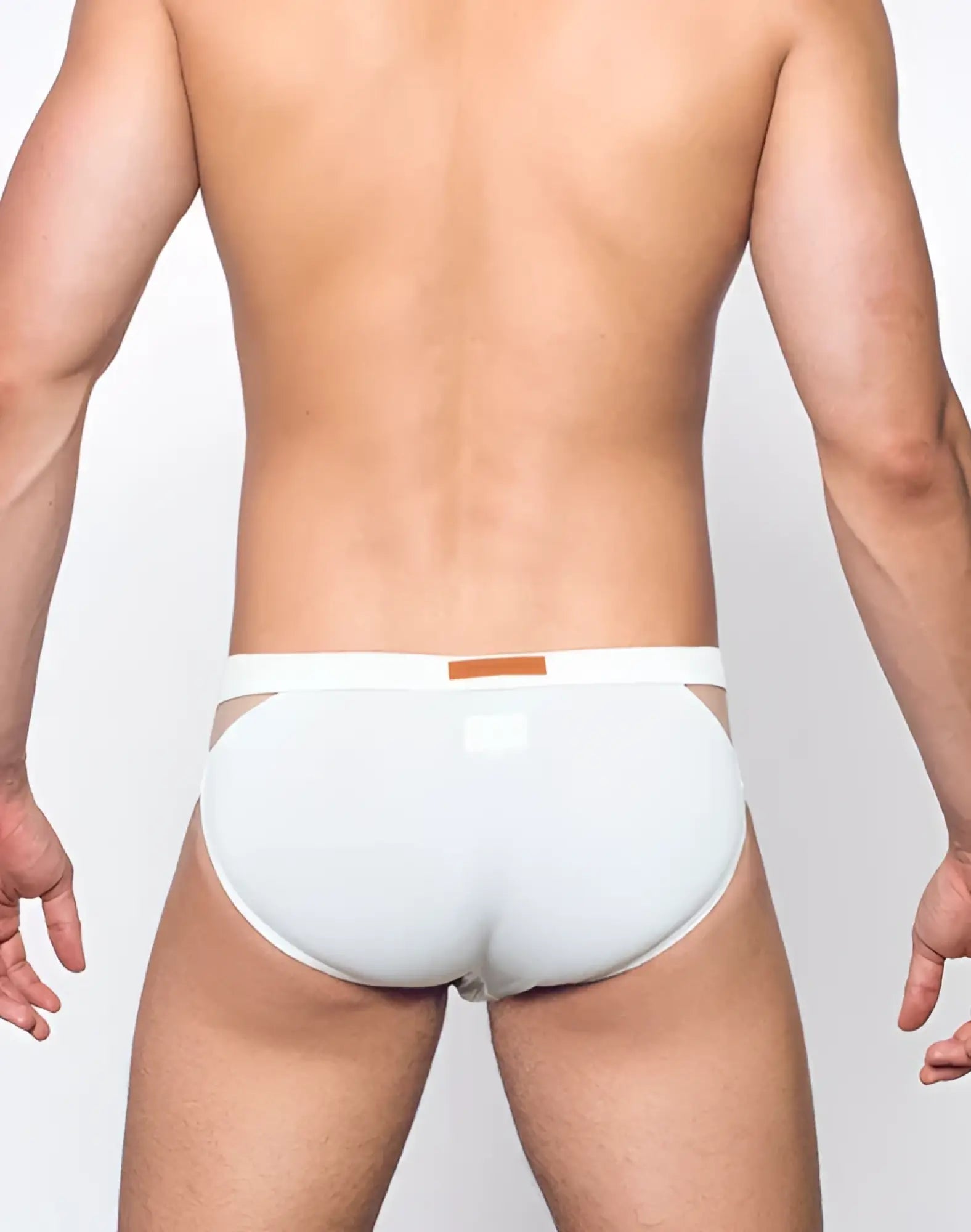 White vb21 blk label swim brief with thin waistband and orange rectangular tag designed for swimwear use