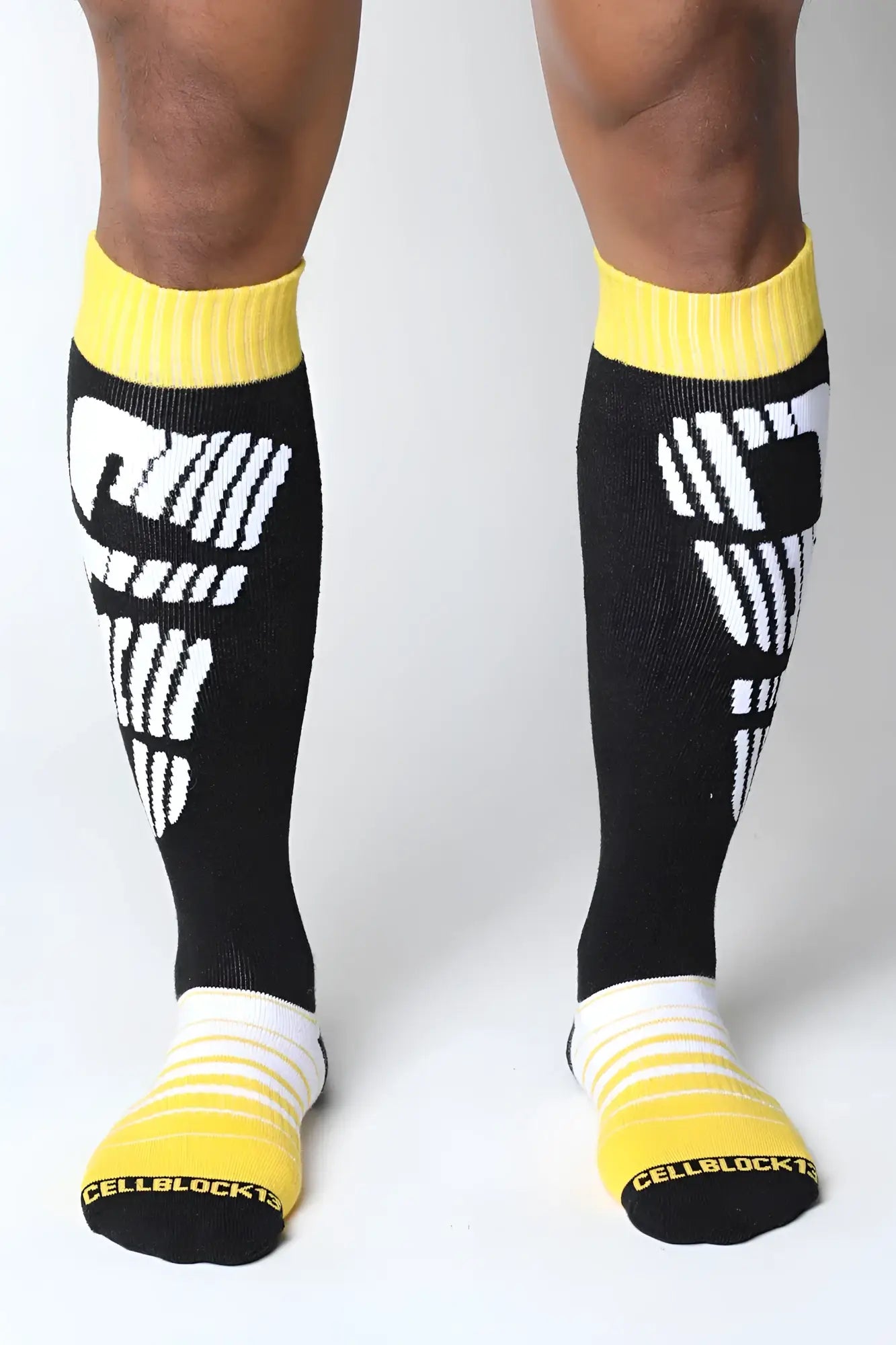 Black velocity 2.0 knee high socks with bold white graphic and bright yellow ribbed cuffs toe caps and heel accents