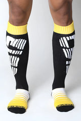 Black velocity 2.0 knee high socks with bold white graphic and bright yellow ribbed cuffs toe caps and heel accents