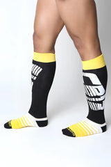 Velocity 2.0 knee high socks in black and yellow with bold white graphic design for athletic wear