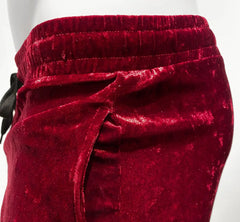 Velvet pocket shorts in rich crimson velvet with a soft plush texture and elastic waistband for comfortable wear