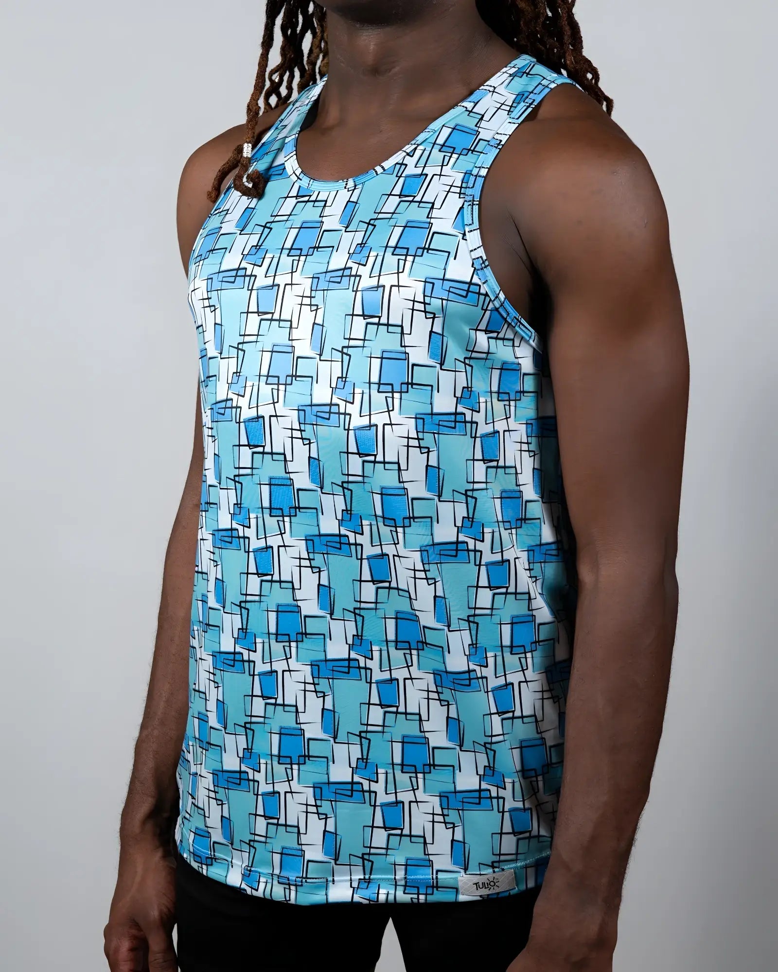 A men’s wallpaper print tank top with overlapping blue squares on white made from lightweight fabric