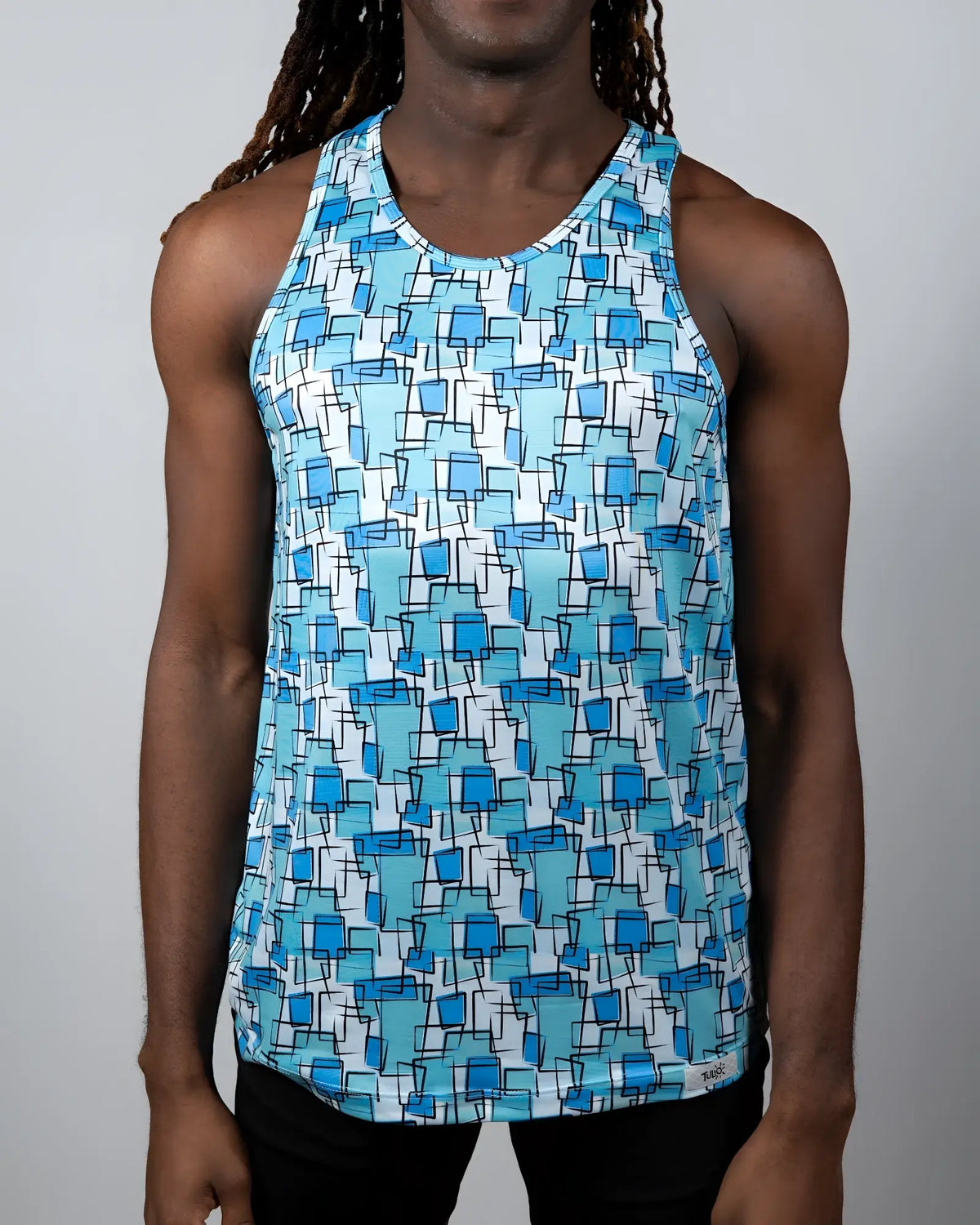 A men’s wallpaper print tank with a vibrant blue geometric pattern of squares and rectangles on a white background