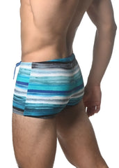 Blue and white striped swim trunks with a textured watercolor stripe printed pattern for beachwear