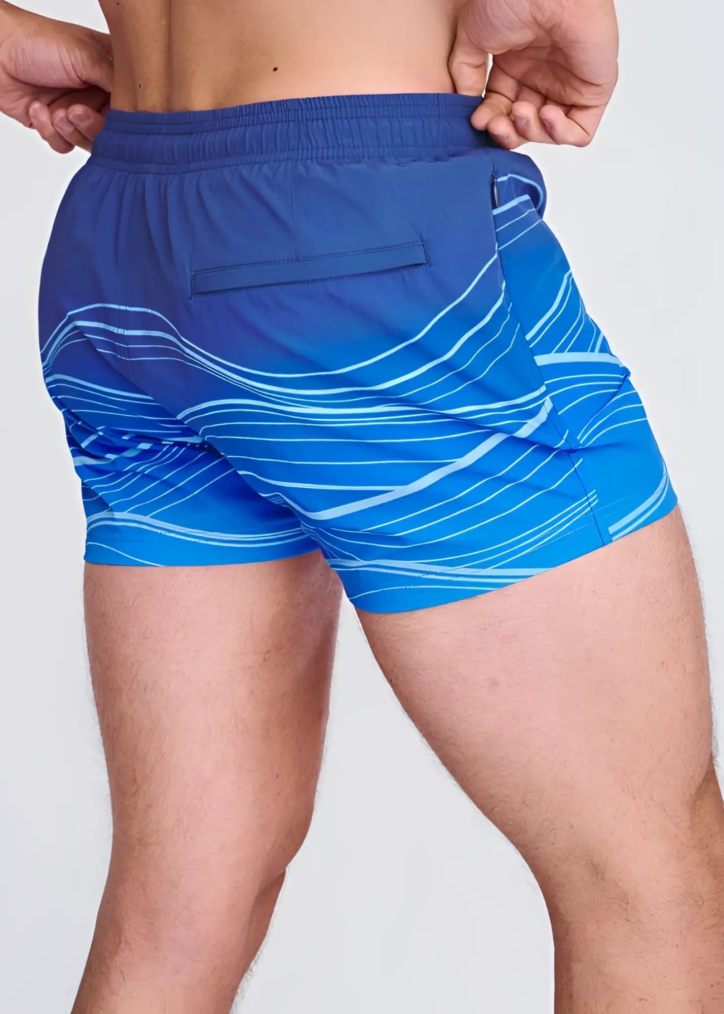 Blue waves print swim shorts with white wavy line pattern and mesh lining for comfortable water activities