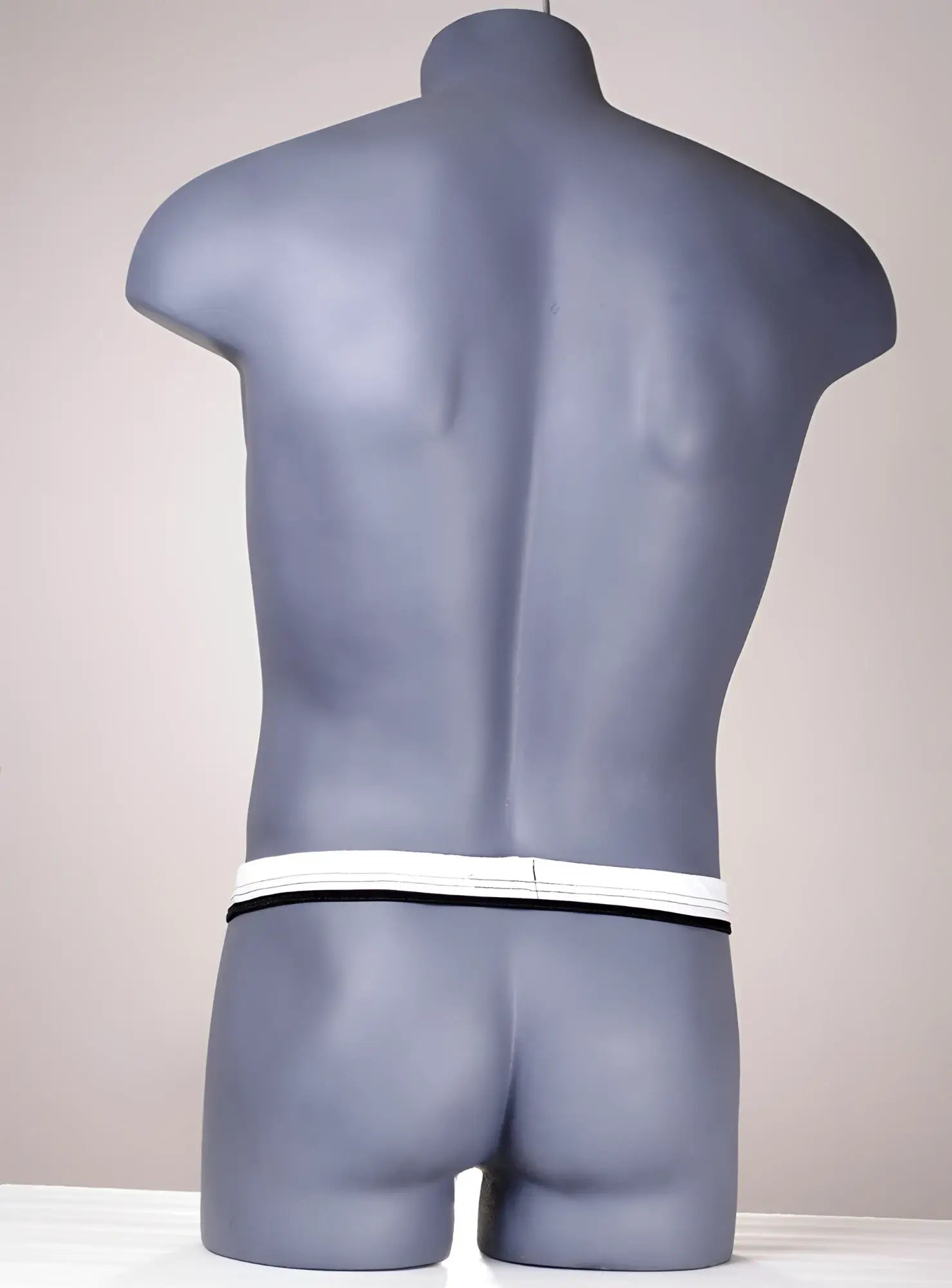 Gray mannequin torso wearing wildmant the ball lifter protruder 2 with white and black striped waistband