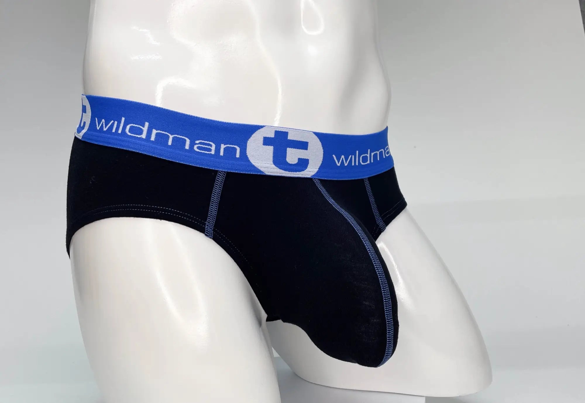 Black cotton men’s briefs with a blue wildman elastic waistband featuring the big boy pouch design