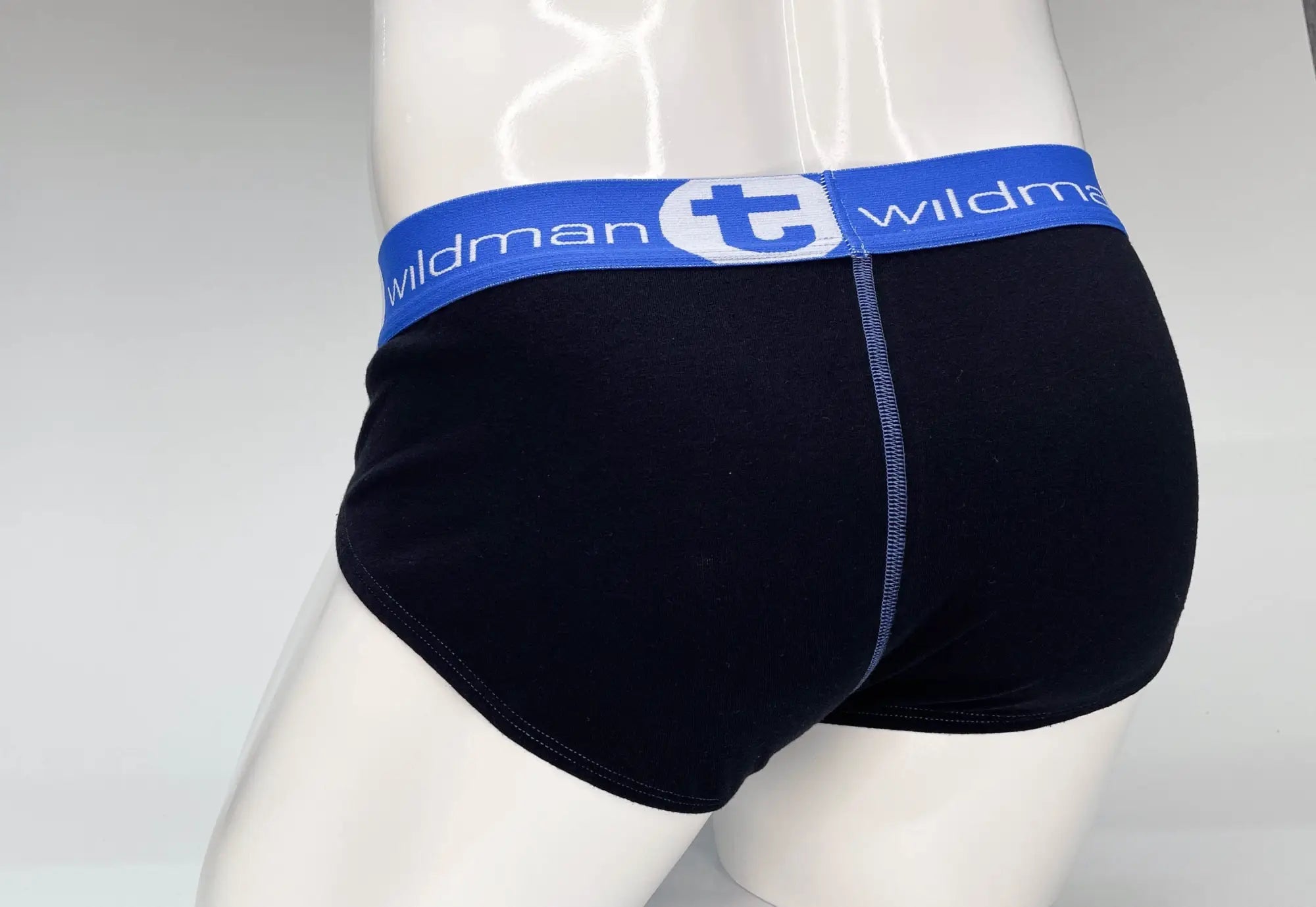 Black cotton briefs with blue waistband featuring wildman brand logo and white lettering wildmant big boy pouch