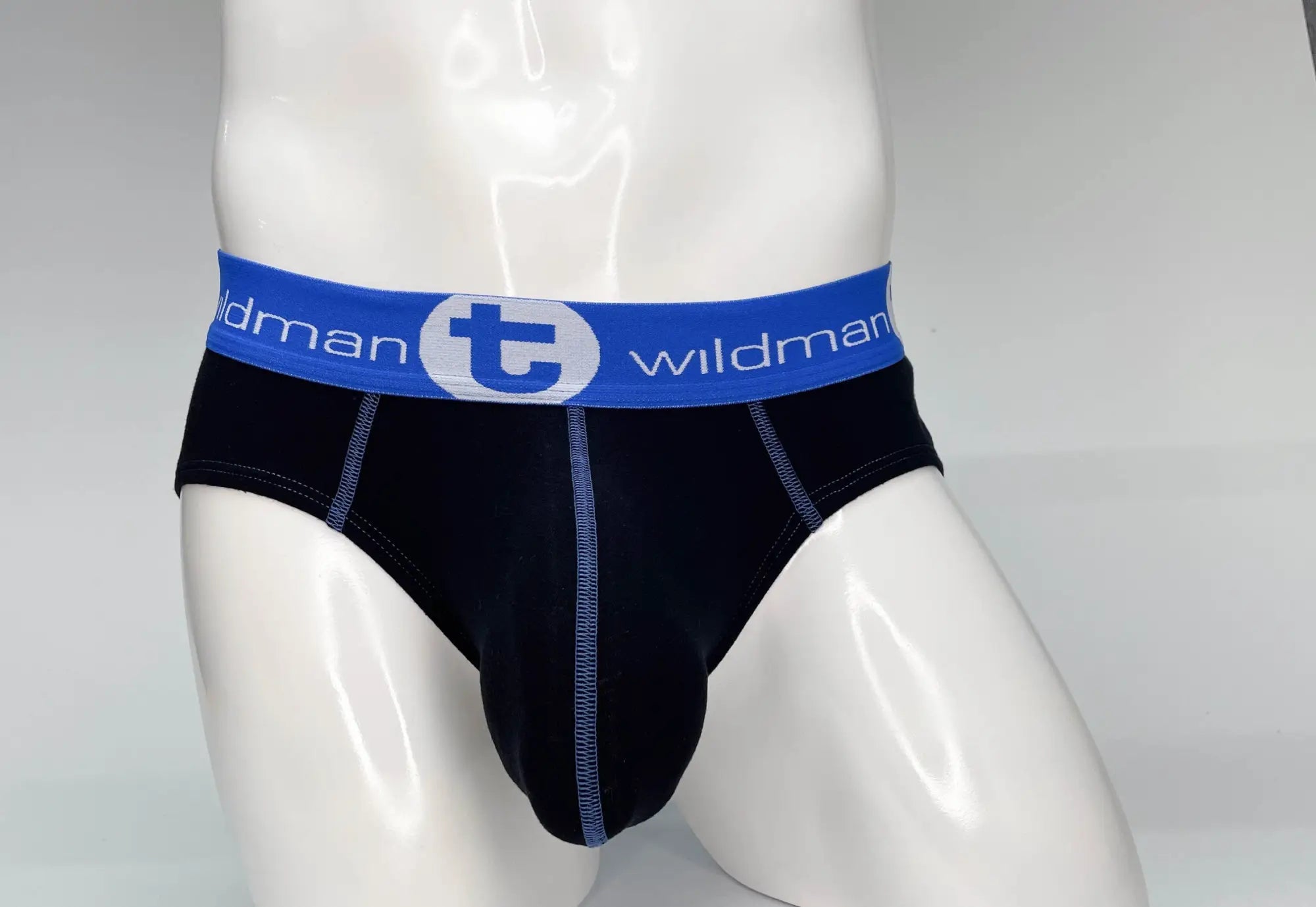 Black cotton briefs with blue waistband featuring wildman logo and white lettering big boy pouch design