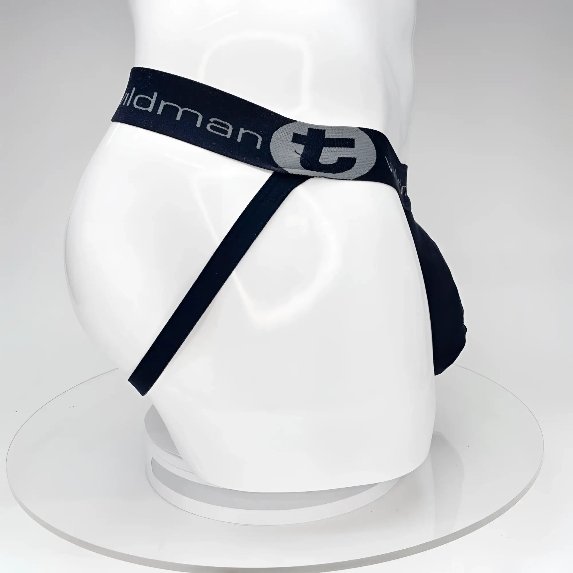 Black wildmant big boy pouch jockstrap briefs with navy waistband featuring tildman logo and stylized t emblem