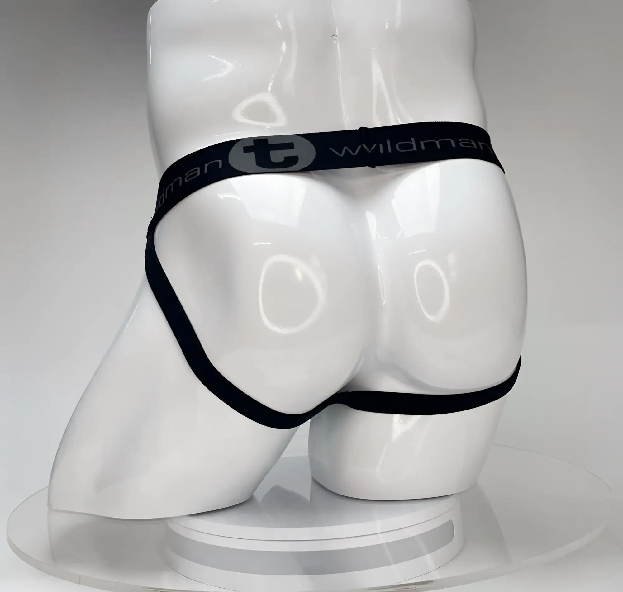 Black elastic waistband briefs with wildman branding on white mannequin from wildmant big boy pouch jockstrap white collection