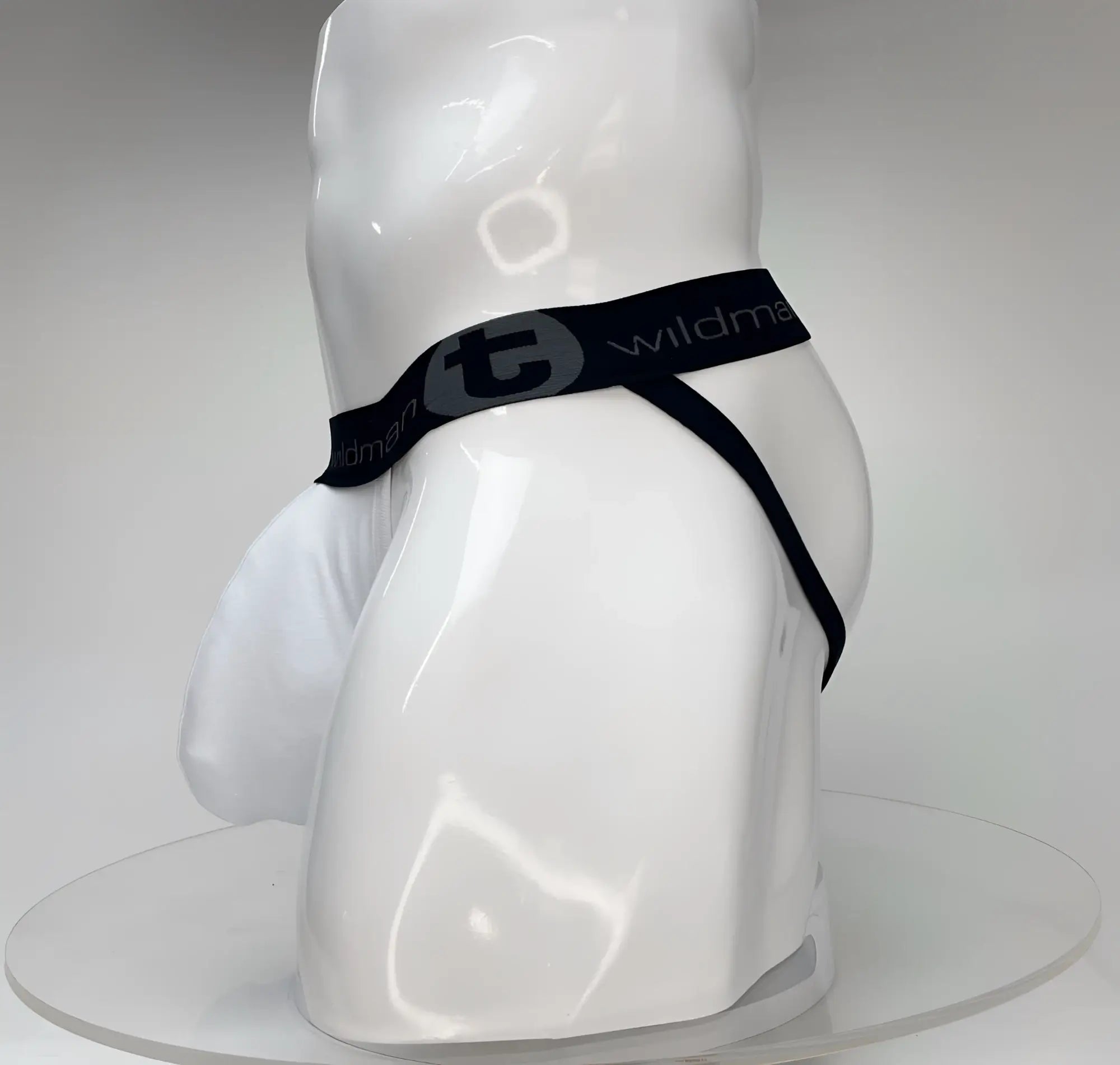 Wildmant big boy pouch jockstrap in white with black elastic waistband and wildman branding on a white mannequin