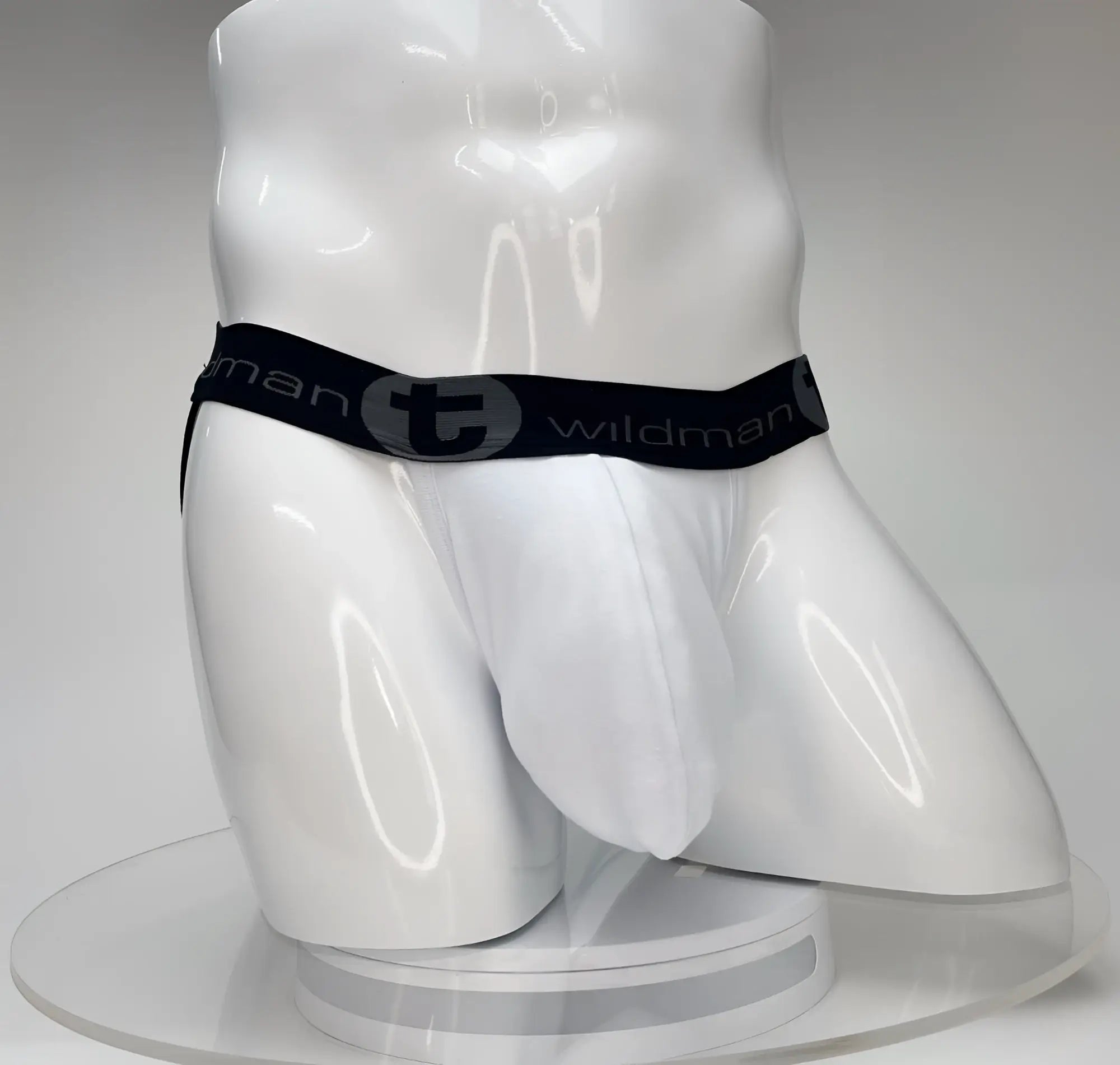 White wildmant big boy pouch jockstrap with black elastic waistband and stylized t emblem front view