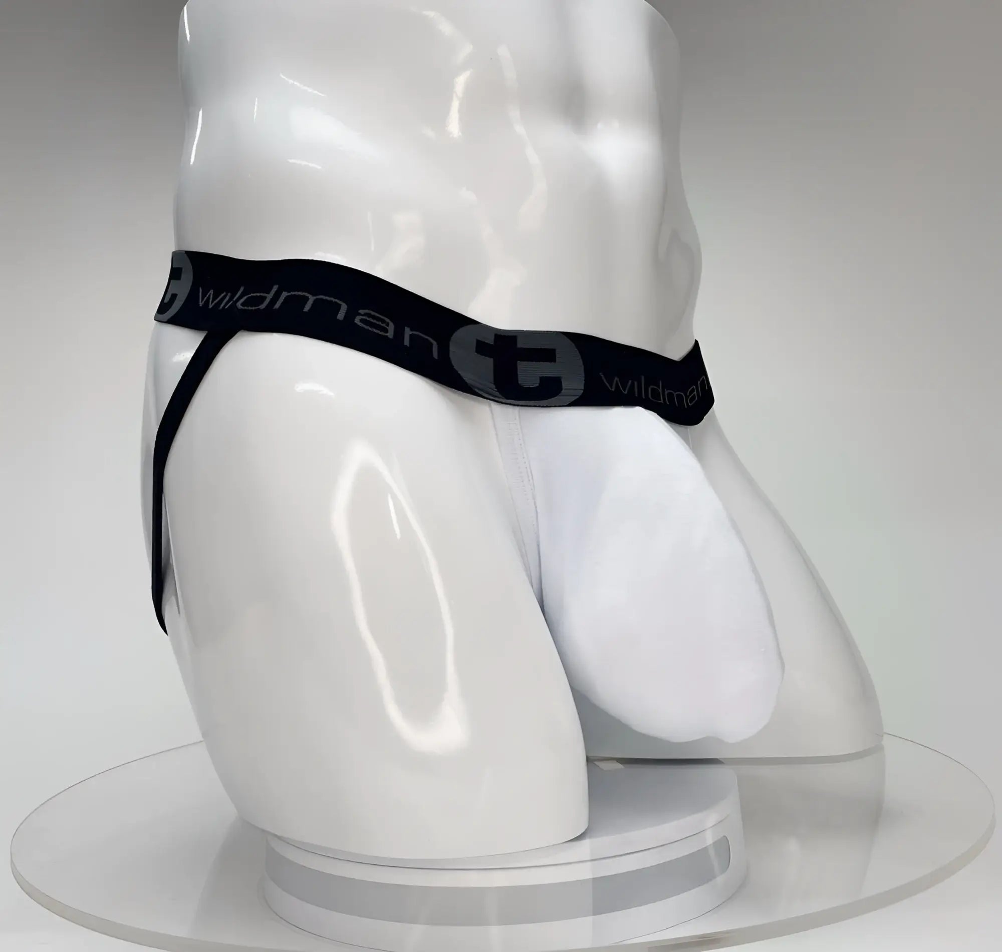 White wildman big boy pouch jockstrap briefs with black elastic waistband featuring wildman logo and stylized t emblem