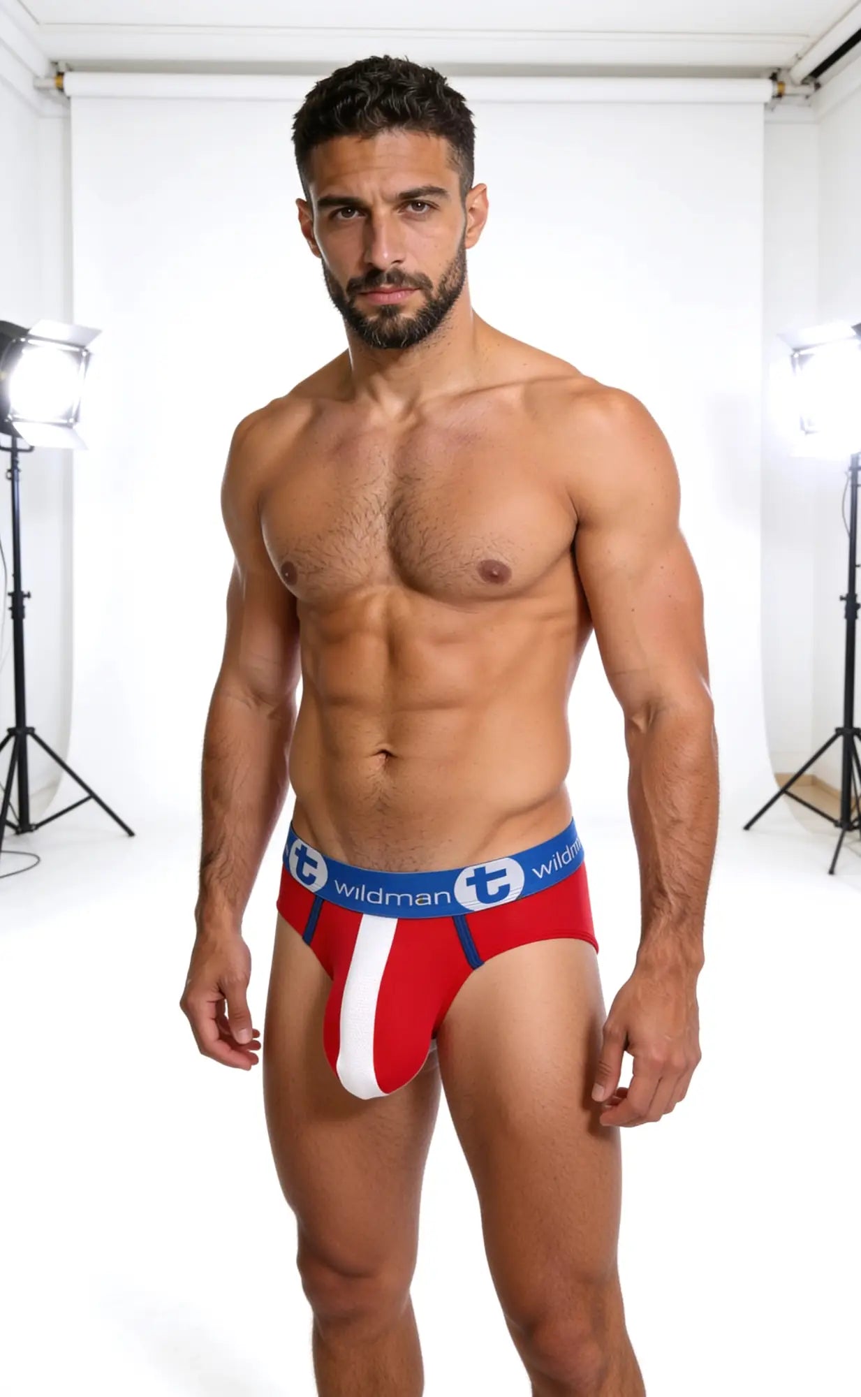 Front view of a man wearing red, white, and blue WildmanT mesh briefs with a logo waistband.