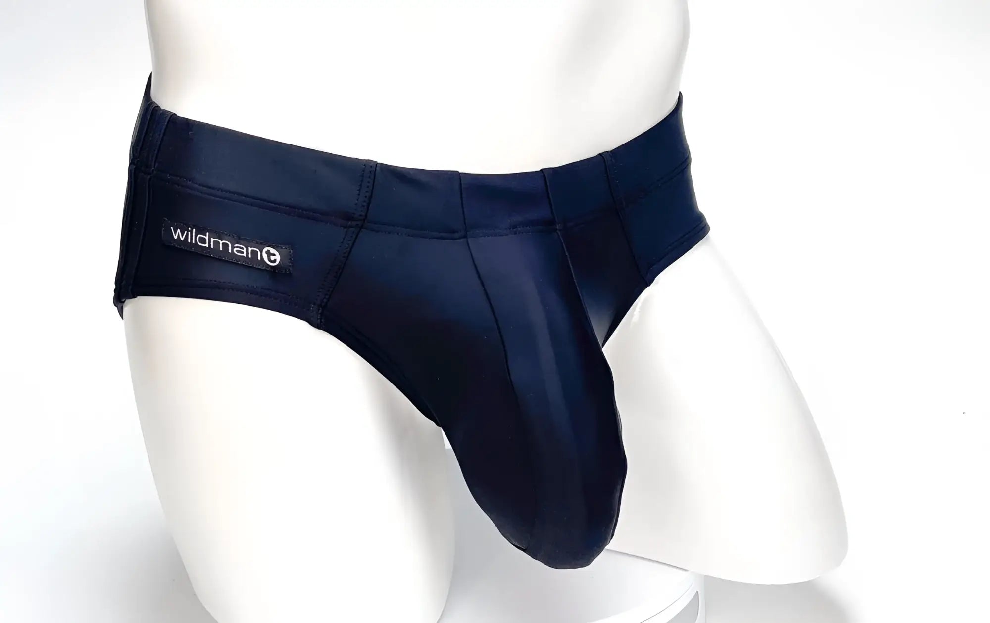 Navy blue satin swim briefs with big boy pouch and black wildman brand label on waistband for men