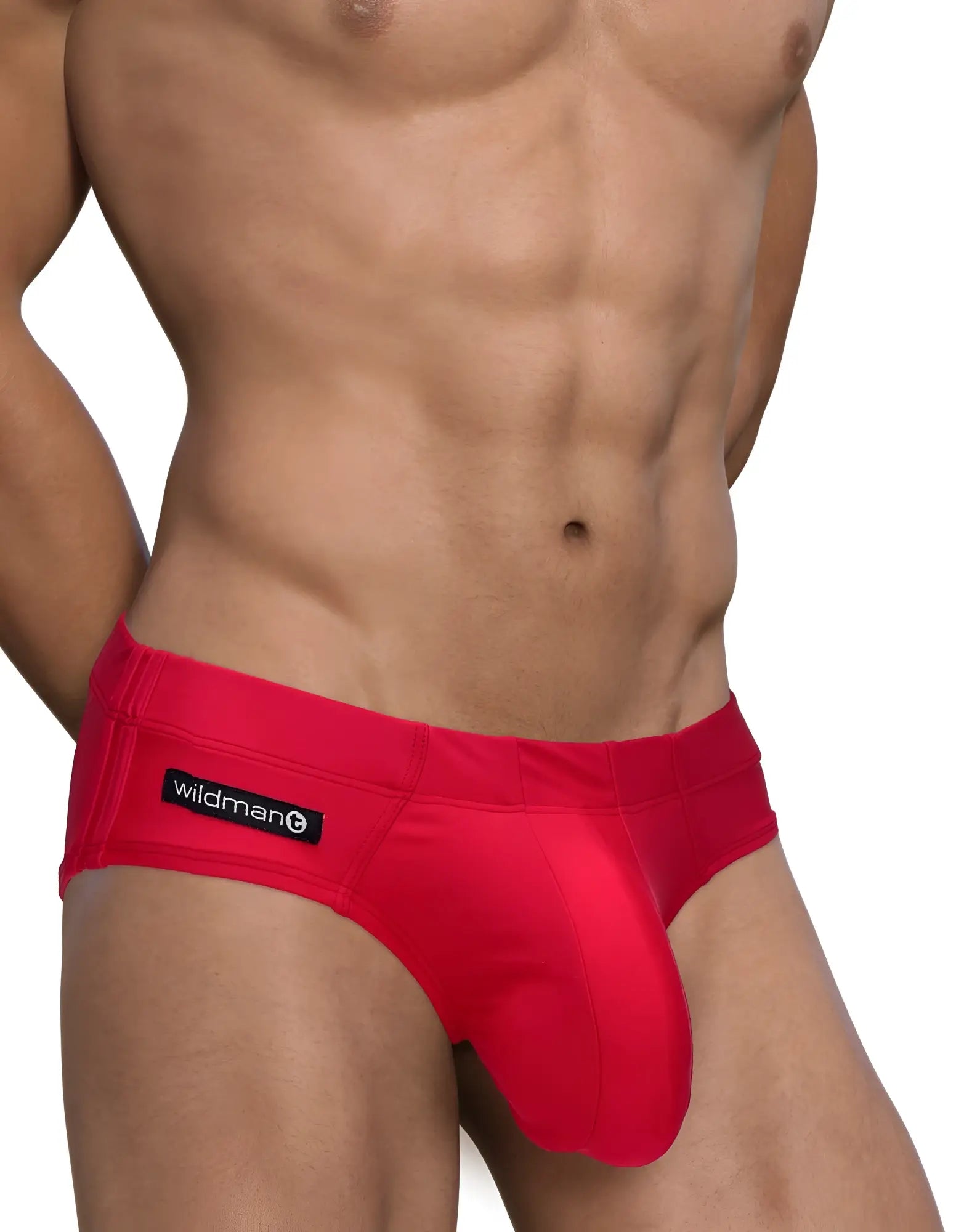 Bright red form-fitting men’s swim briefs with black wildman brand label on waistband big boy pouch design