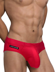 Bright red form-fitting men’s swim briefs with black wildman brand label on waistband big boy pouch design