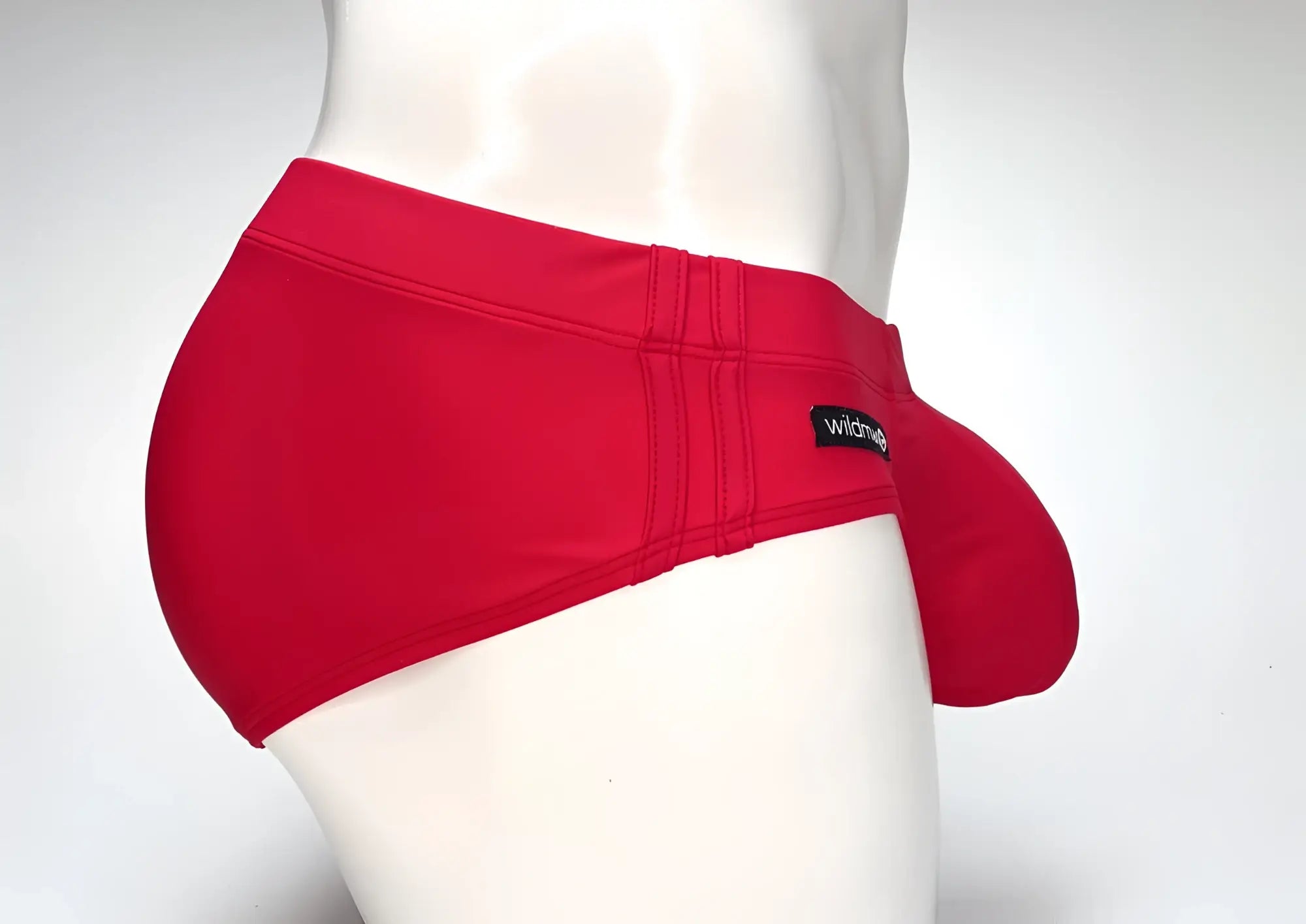 Red mens WildmanT big boy pouch swim brief with black brand tag on waistband designed for swimming use
