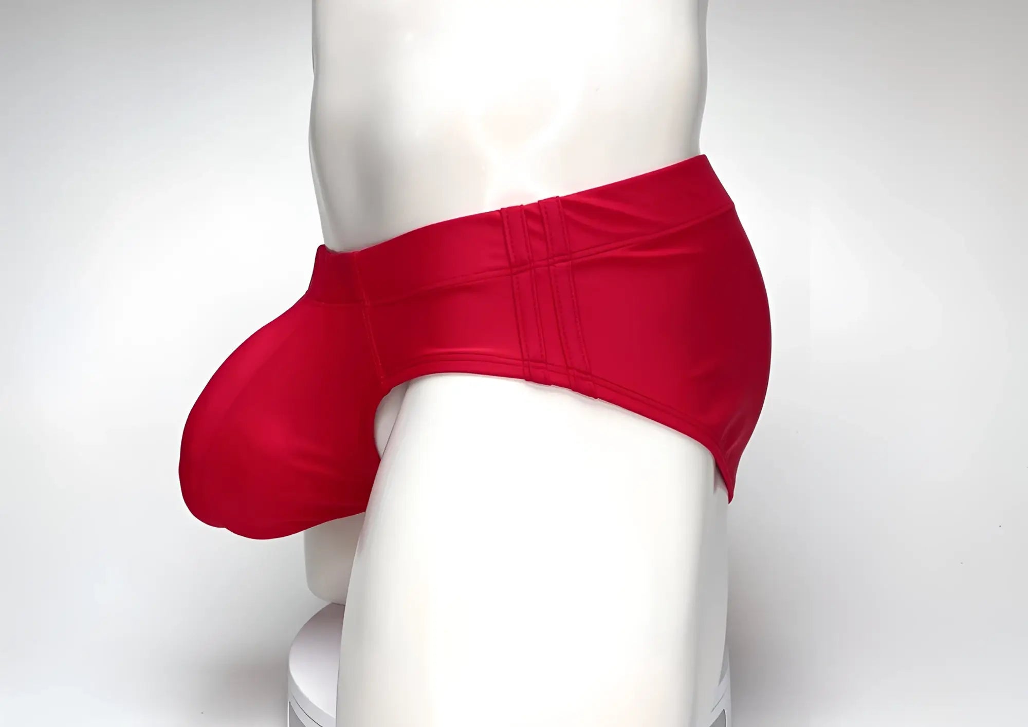 WildmanT big boy pouch swim brief in red with form-fitting glossy fabric and subtle vertical seam detailing