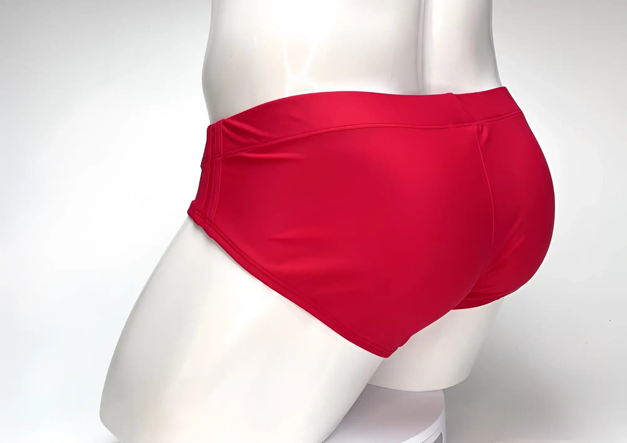 Vibrant red WildmanT big boy pouch swim brief with smooth glossy fabric finish designed for swimming