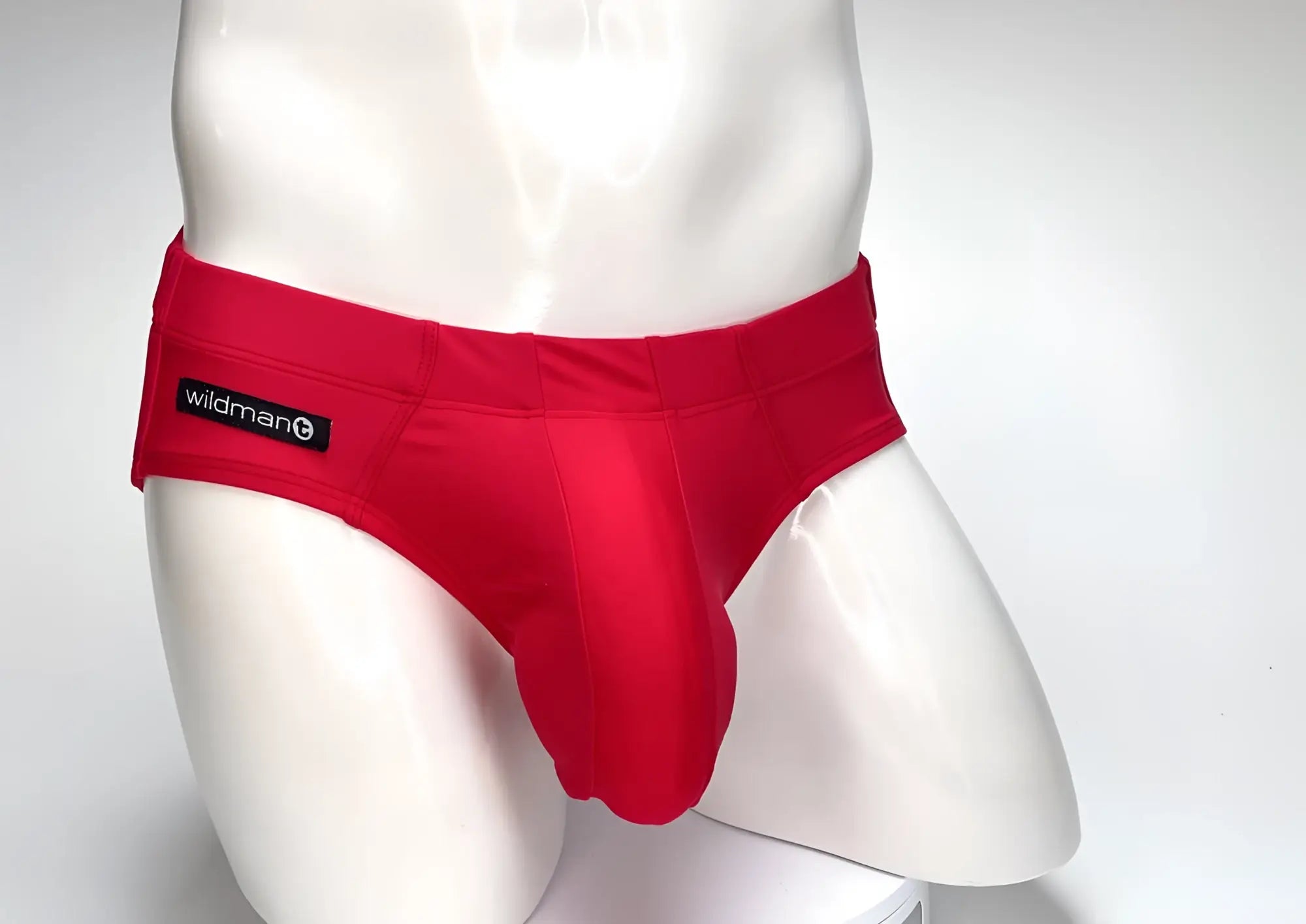 Red wildman big boy pouch swim brief with smooth form-fitting fabric and black waistband label for men