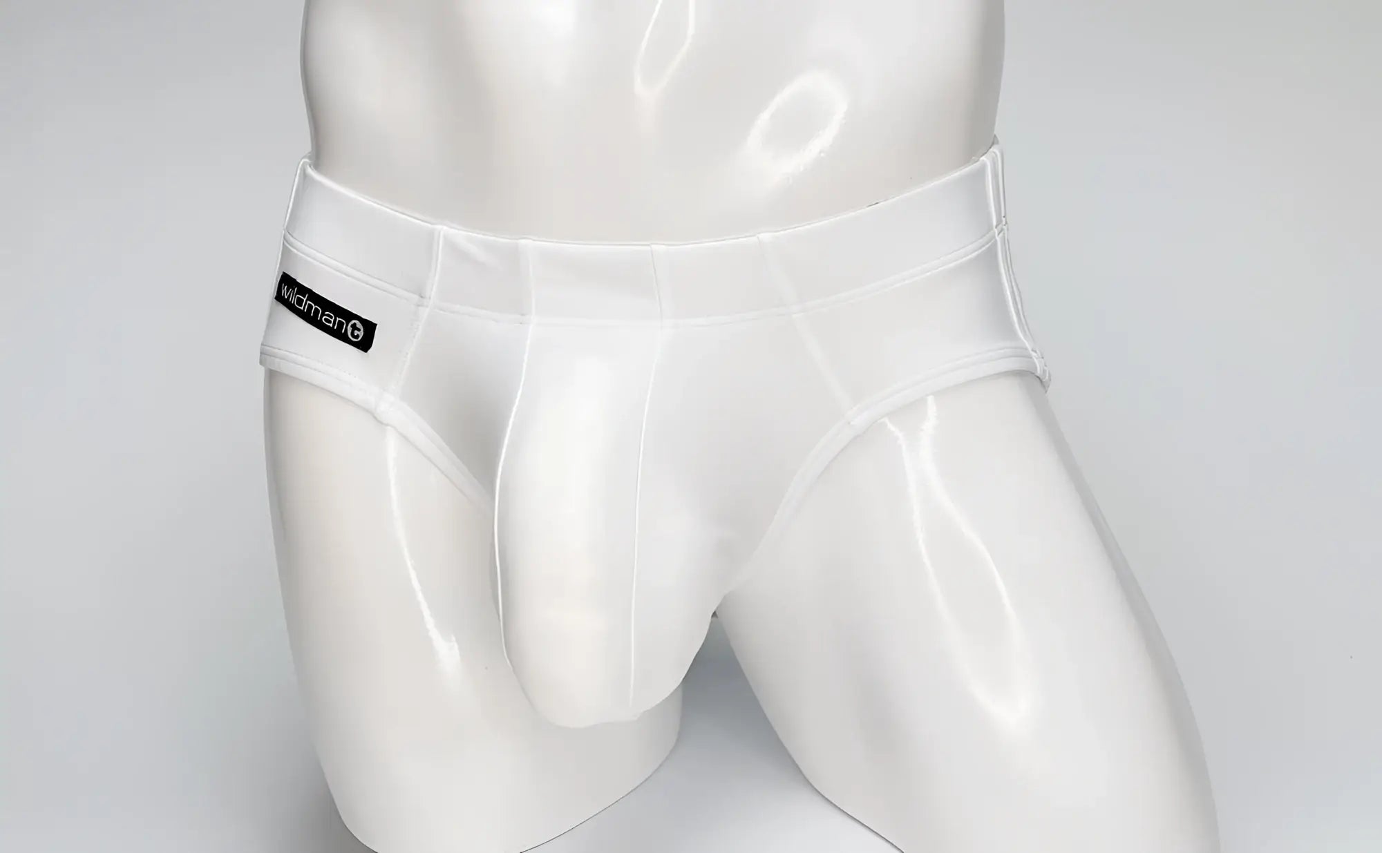 White glossy latex wildmant big boy pouch swim brief with black wildman brand label on the waistband