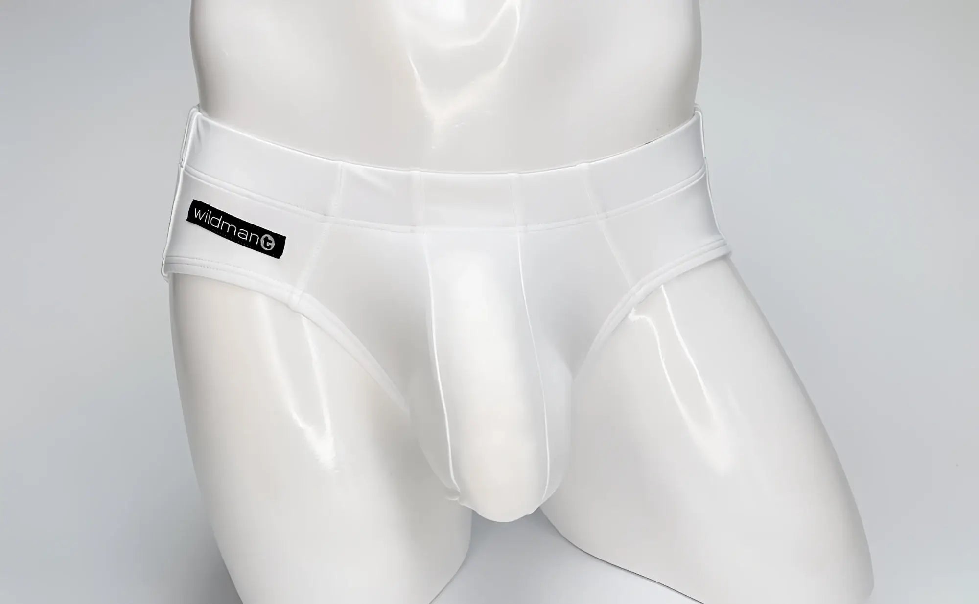 White glossy latex wildmant big boy pouch swim briefs with black wildman label on waistband