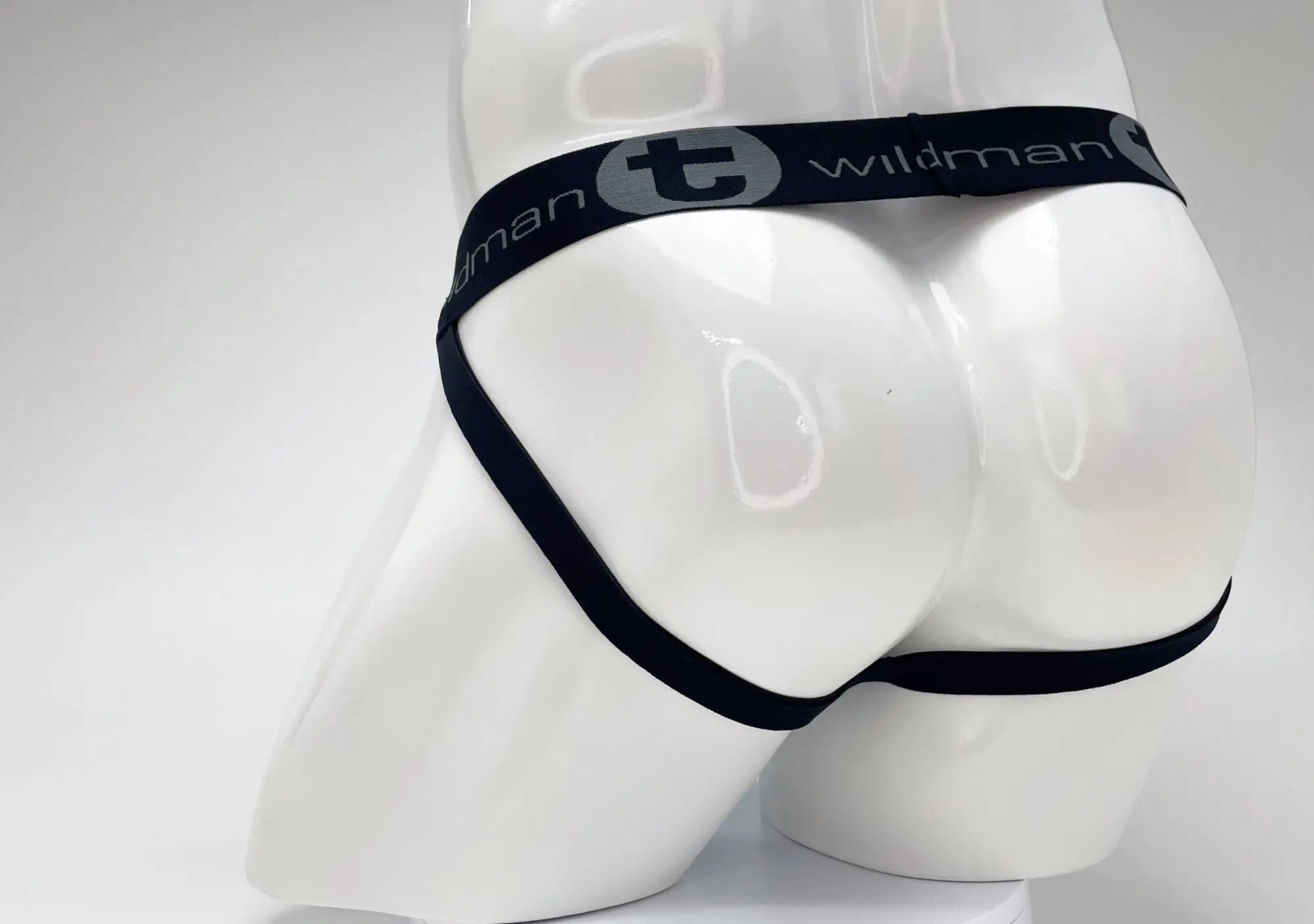 Black elastic waistband with wildman branding on white mannequin for wildmant cotton big boy pouch stripe jockstrap