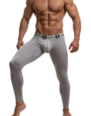 Gray wildman compression tights with black waistband featuring wildman logo and stylized t emblem in cotton long johns