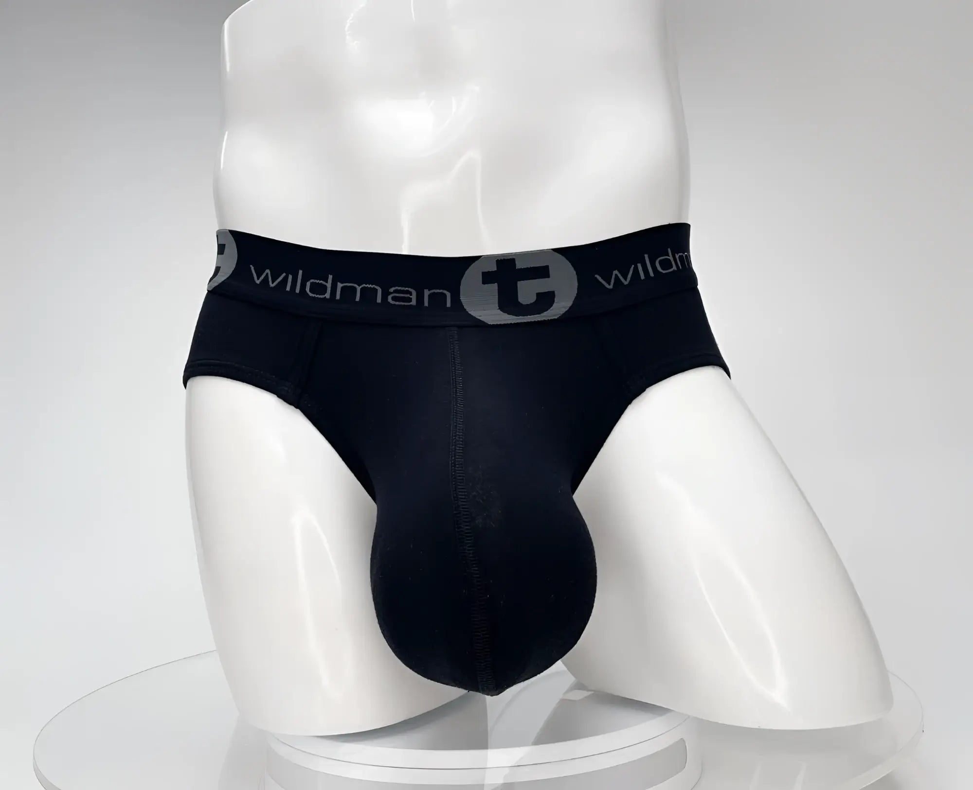Black wildman cotton monster cock brief with gray waistband featuring wildman logo and circular emblem